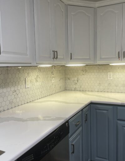 White kitchen cabinets and countertop by Solid Surfaces NY